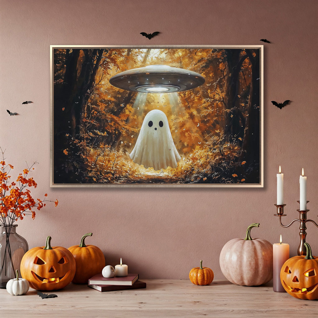 Framed Wall Art featuring a whimsical ghost under a UFO in a fall forest scene, warm orange and brown tones, perfect Halloween decor.