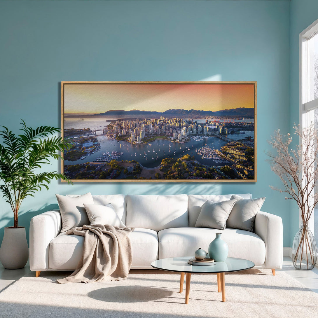 Framed Wall Art of Vancouver cityscape in warm tones, displayed in a modern living room with a teal wall and white sofa.