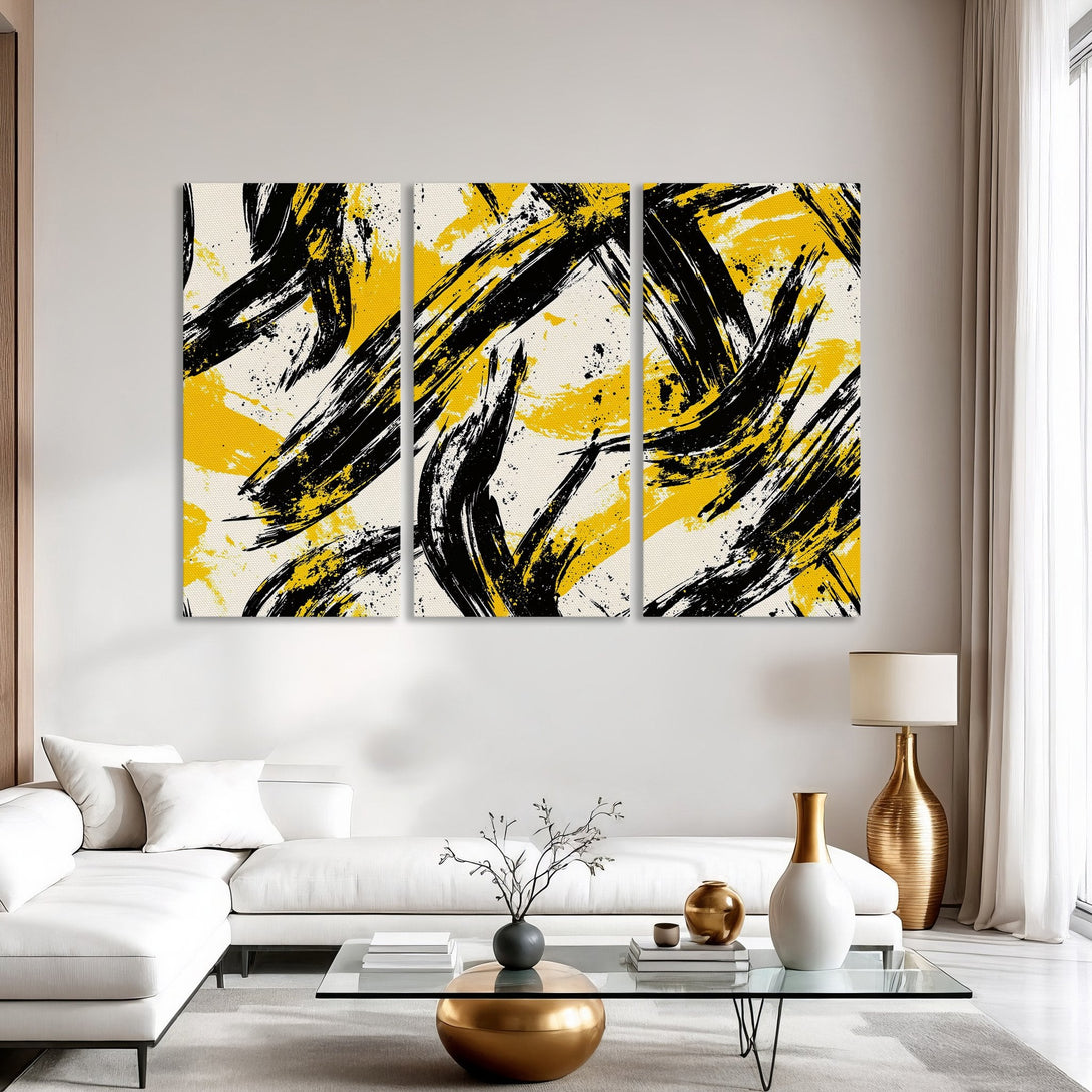 Abstract Canvas Print art in a modern interior. Features bold black brushstrokes on a yellow and cream backdrop, perfect for a stylish home.