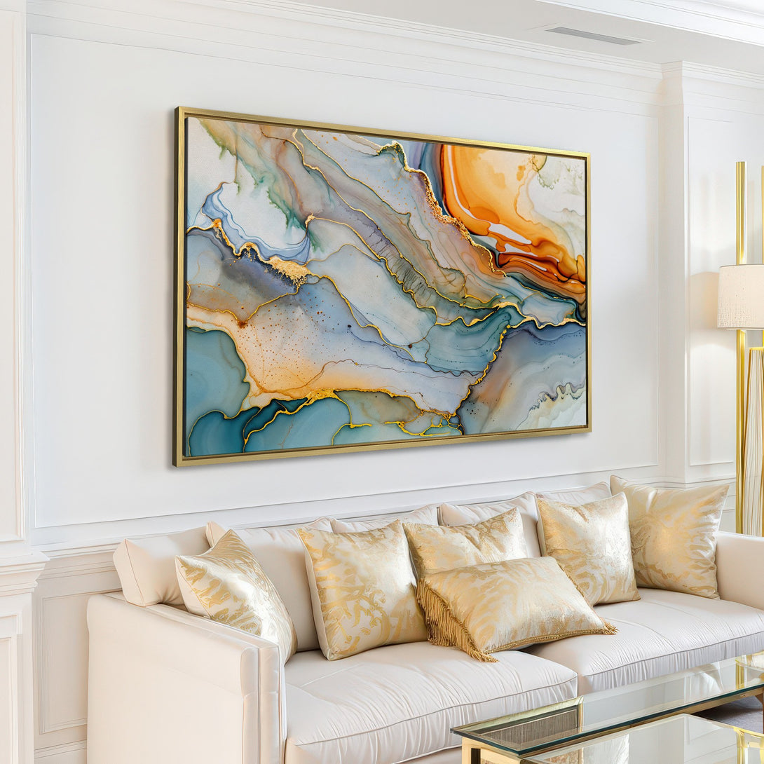 Abstract Canvas Print in a modern living room. Features fluid art style with gold accents, blue, and orange tones. Perfect wall art for your home!