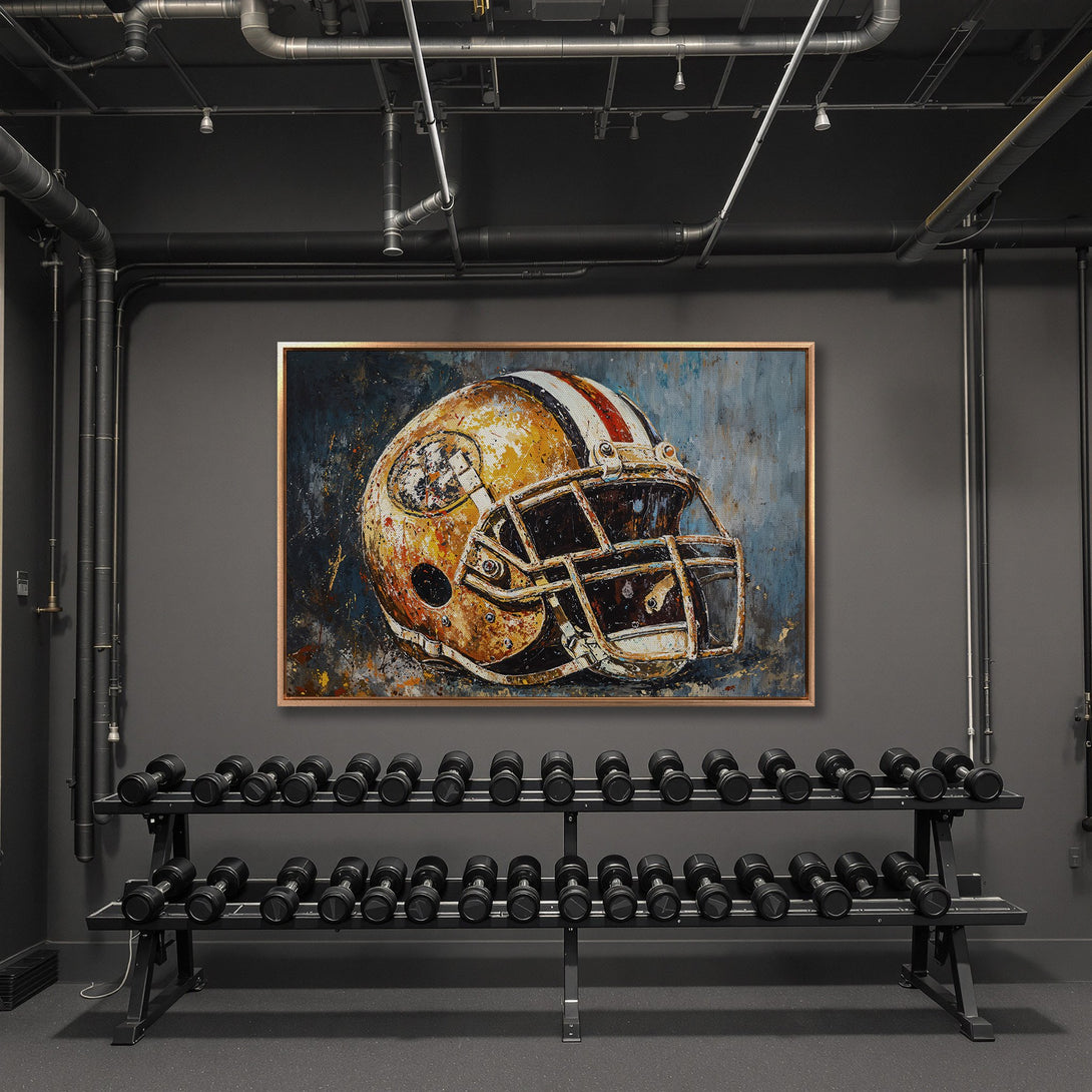 Framed Wall Art: Abstract football helmet painting in a gold frame. Rustic style with a warm, earthy color palette. Adds a bold statement to any space.