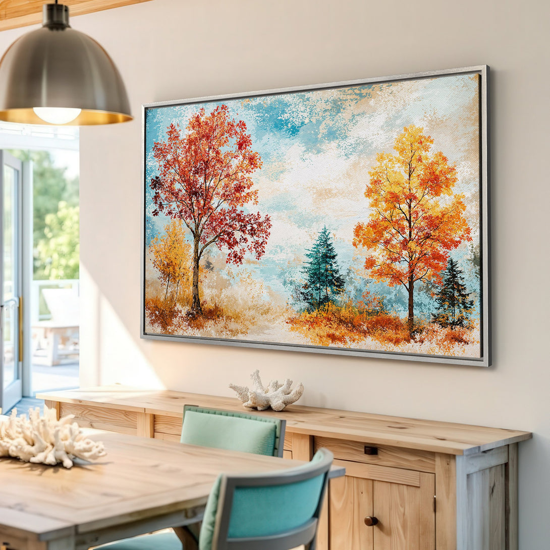 Framed Wall Art: Autumn landscape Canvas Print with trees in vibrant orange and red hues, set against a blue and beige background.