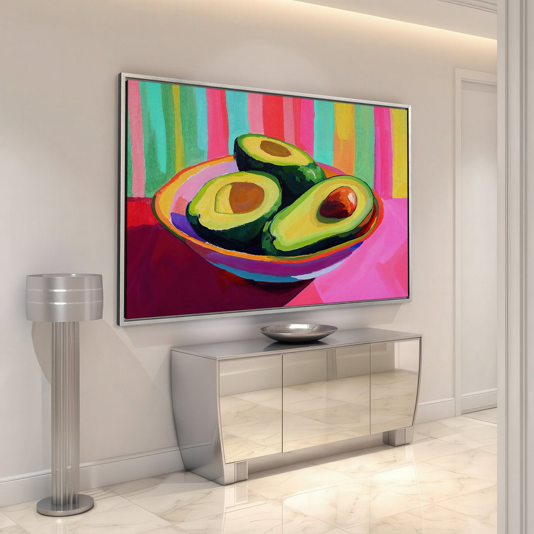 Framed Wall Art: Vibrant avocado painting with a colorful, abstract style. Bold pinks, greens, and yellows add a pop of art to any interior space.
