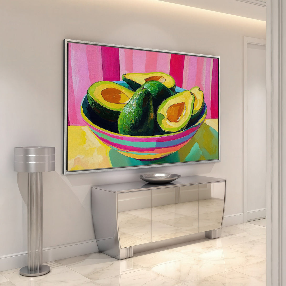 Framed Wall Art: Vibrant avocado still life painting. Modern, colorful artwork with a bold pink, green, and yellow palette. Perfect for kitchen or dining room decor.