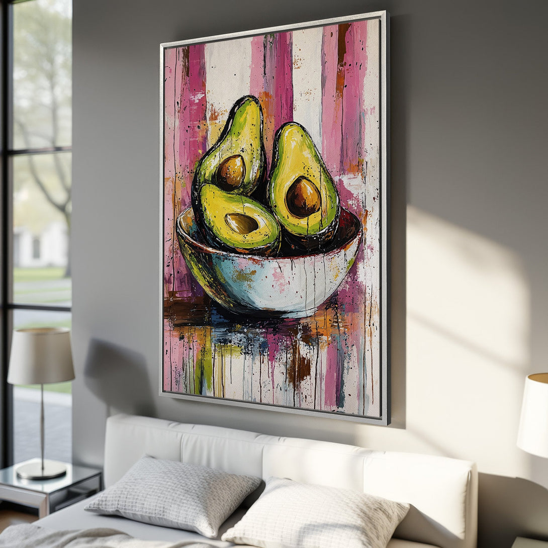 Framed Wall Art: Vibrant avocado painting with pink & yellow abstract background. Modern art canvas print in a bedroom setting. Add color to your space!