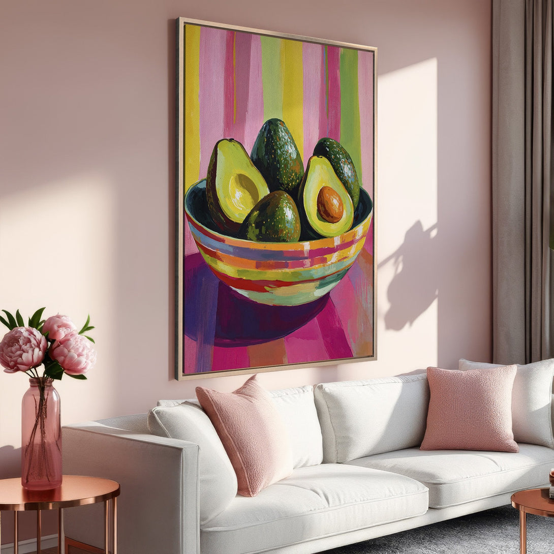 Framed Wall Art: Vibrant avocado still life painting with a colorful striped background. Perfect kitchen or dining room decor in pink, green, and yellow hues.