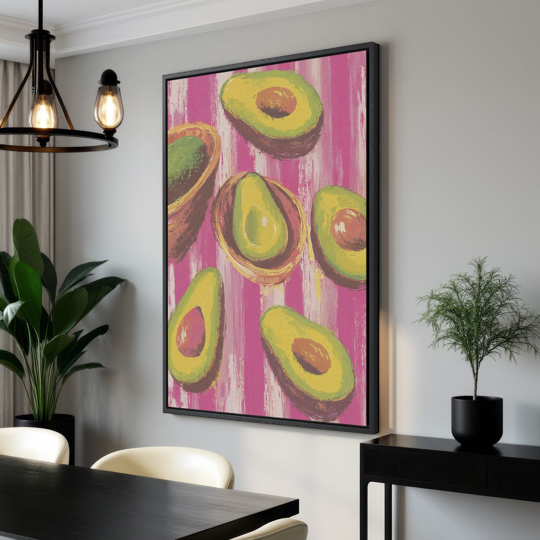 Framed Wall Art featuring vibrant avocado slices on a pink striped background. Modern, colorful canvas print perfect for kitchen or dining room decor.