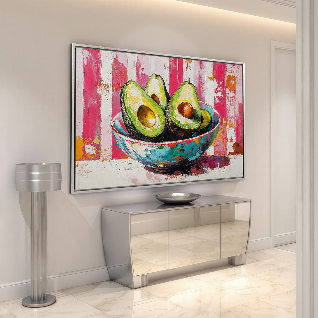 Framed Wall Art featuring a vibrant avocado still life. Modern, colorful painting with green, pink, and turquoise hues. Add a pop of art to your home!