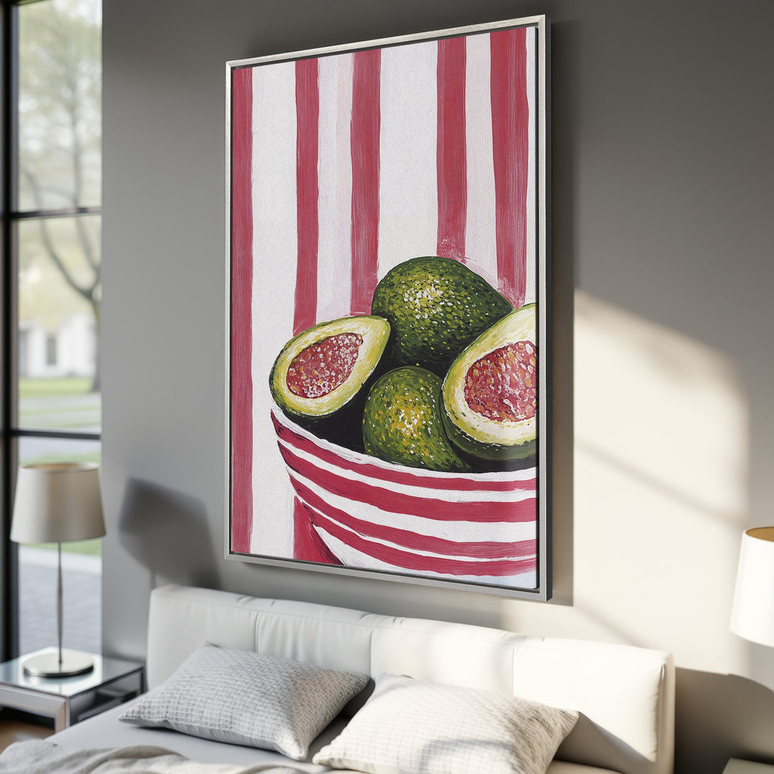 Framed Wall Art: Vibrant avocado painting with red and white striped background, displayed in a modern bedroom. Green, red, and white color palette.