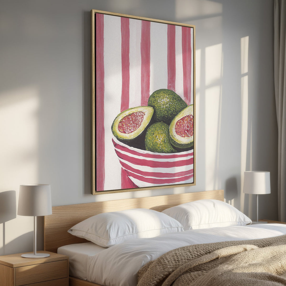 Framed Wall Art: Vibrant avocado painting with a striped background in a bedroom. Features green, red, and white palette. Perfect for kitchen or dining room decor.