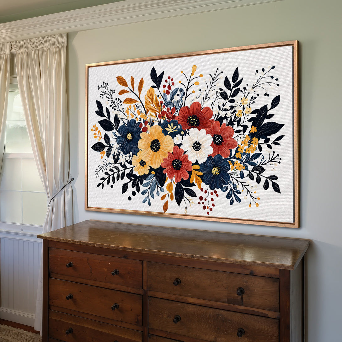 Framed Wall Art: Floral Canvas Print in a room. Features a vibrant bouquet of flowers in red, blue, yellow, and black against a white background. Perfect home decor!