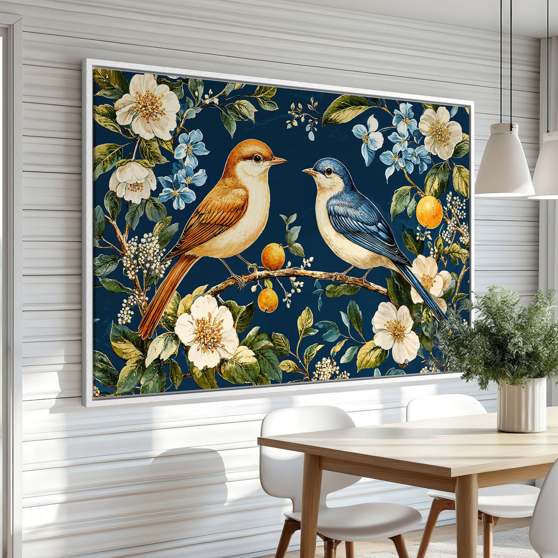 Framed Wall Art featuring two birds on a branch with flowers, in a botanical style. Rich blue, white, and orange color palette. Perfect for home decor.