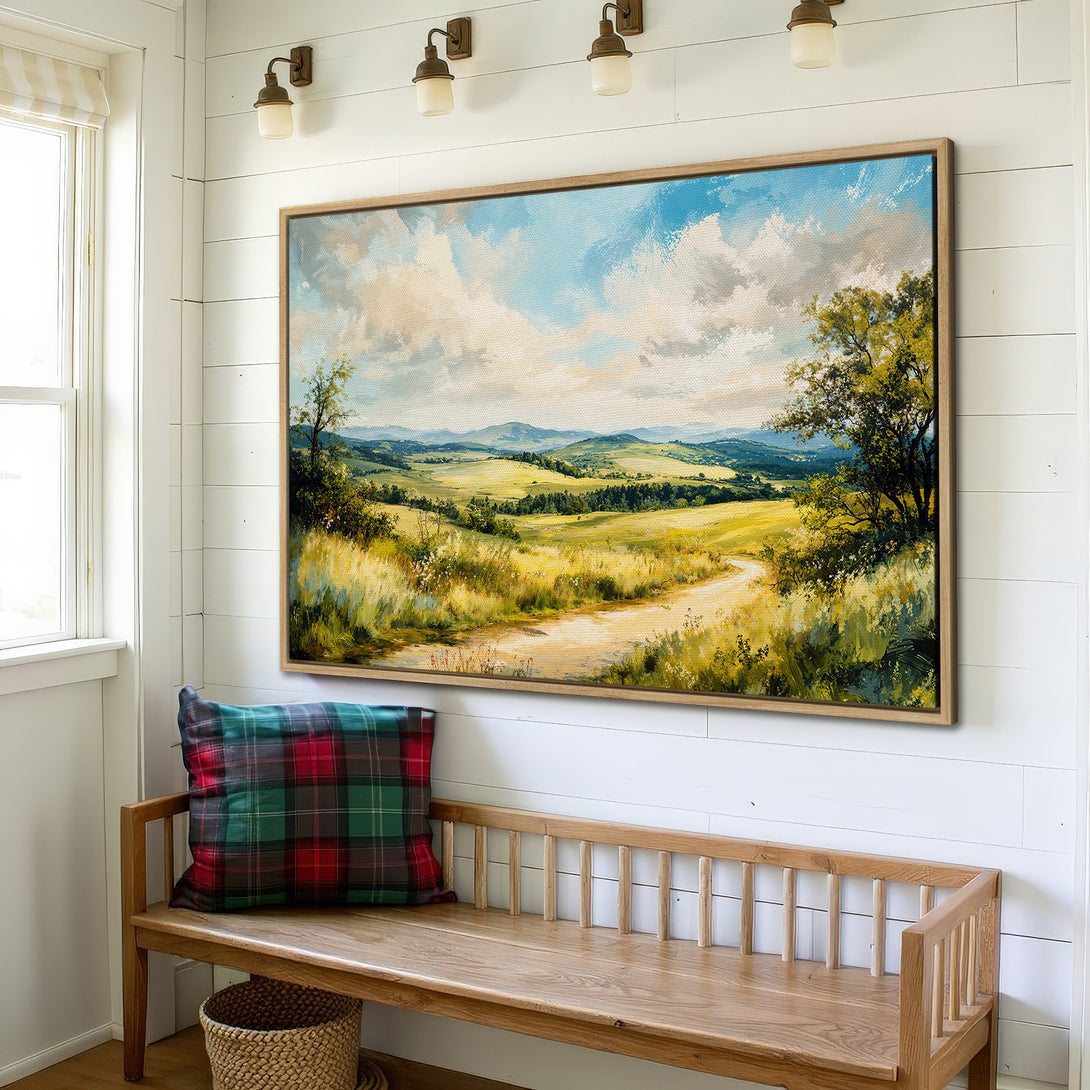 Framed Wall Art featuring a serene landscape painting with rolling hills and a path. Earthy tones of green, yellow, and blue create a calming, rustic aesthetic.