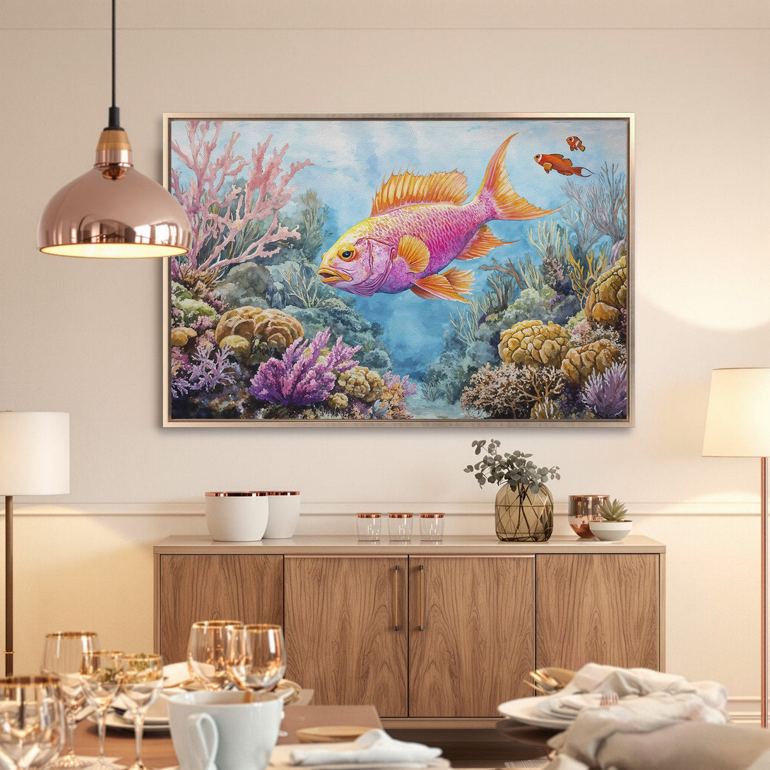 Framed Wall Art: Vibrant watercolor fish painting in a dining room. Colorful underwater scene with pink, yellow, and blue hues. Perfect coastal decor.