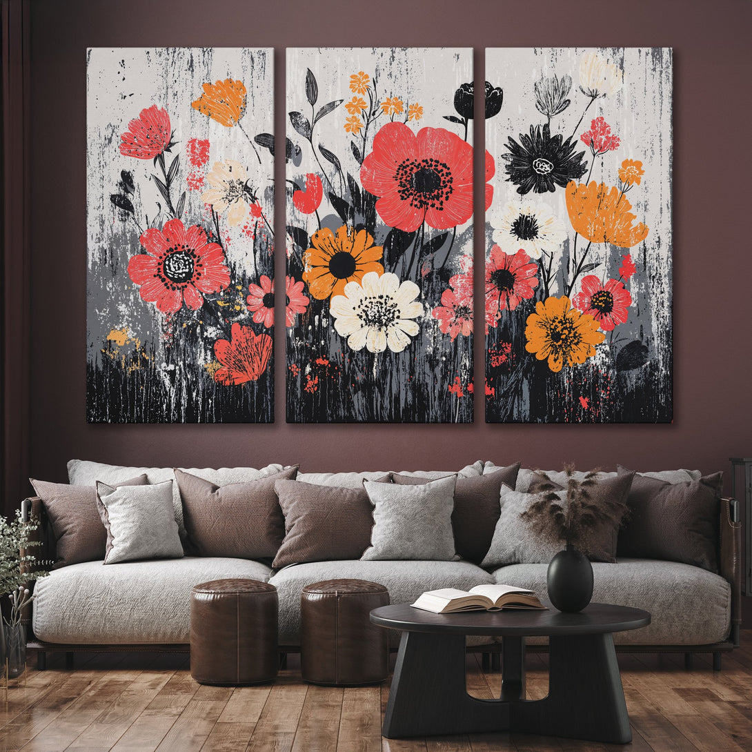 Canvas Print of vibrant floral art in red, orange, and black, displayed in a modern living room with a neutral color palette.