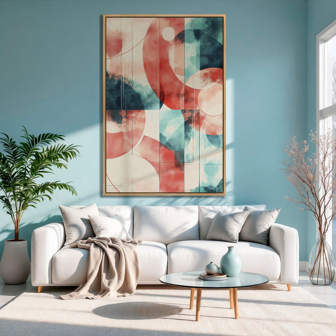 Framed Wall Art featuring abstract geometric design in red, teal, and beige. Modern canvas print adds a pop of color to a stylish living room.