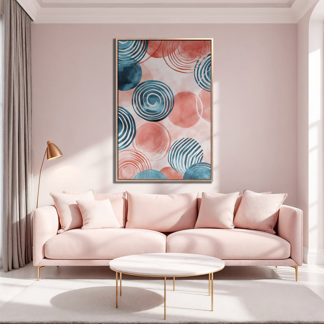 Framed Wall Art featuring abstract circles in teal and coral, displayed in a modern living room. Soft, blush pink color palette creates a calming atmosphere.