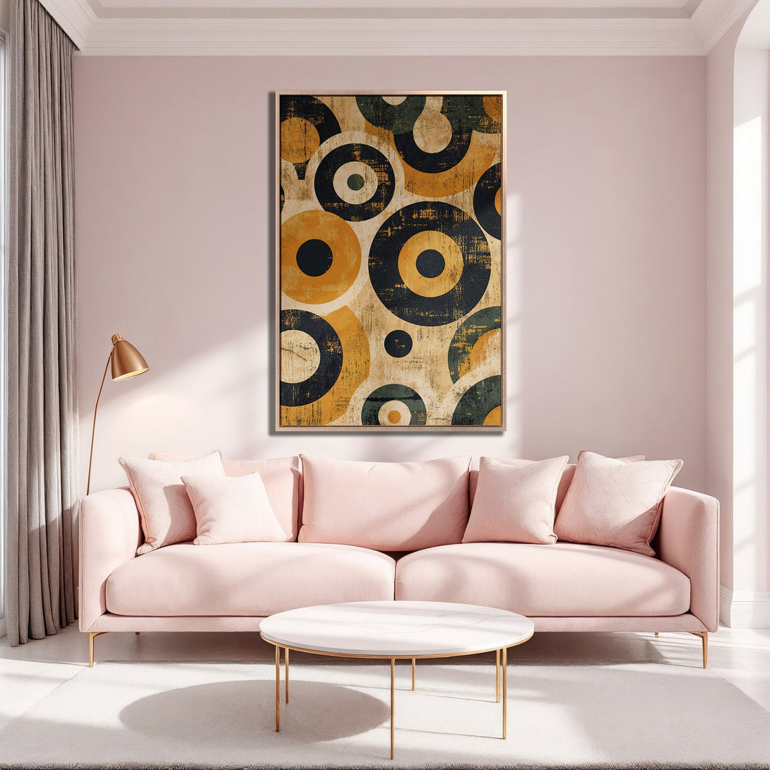 Framed Wall Art in a modern living room. Abstract geometric circles in yellow, black, and green. Adds a pop of color to a blush pink interior.
