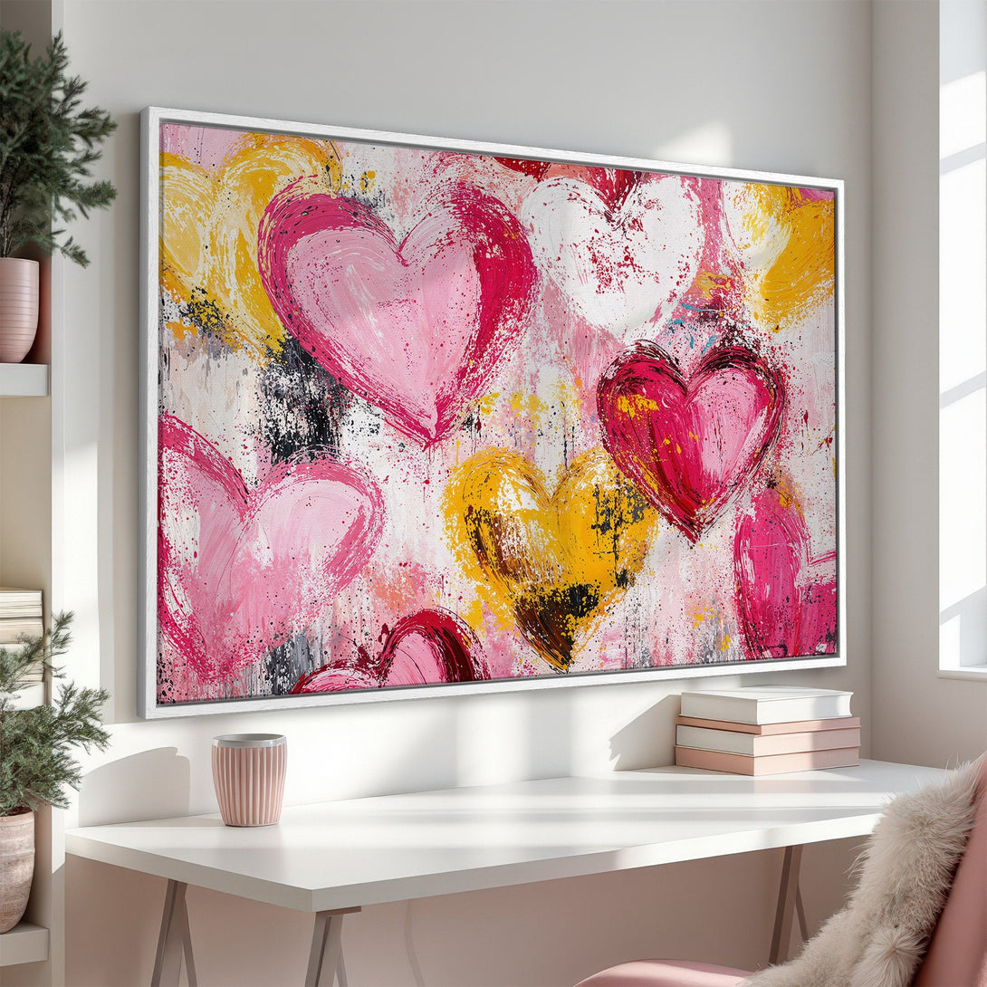Framed Wall Art featuring abstract hearts in pink, yellow, and white. Modern, expressive canvas print perfect for adding love and color to any space.