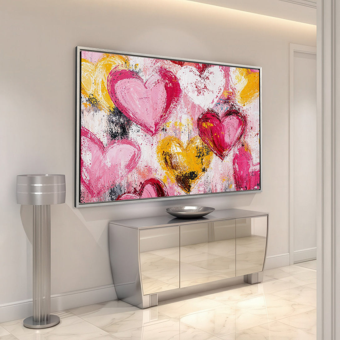 Framed Wall Art featuring abstract hearts in pink, yellow, and red. Modern art canvas print adds a pop of color to any interior.