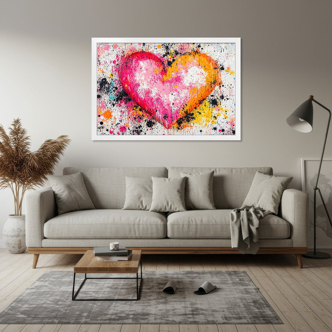 Framed Poster featuring a vibrant, abstract heart in pink, orange, and yellow paint splatter art. Perfect for adding a pop of color!