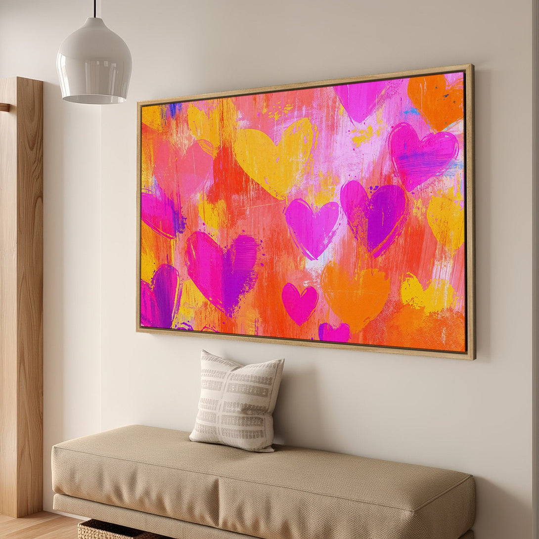 Framed Wall Art featuring an abstract heart design in vibrant pink, orange, and yellow hues. Modern art canvas print perfect for adding a pop of color to any space.