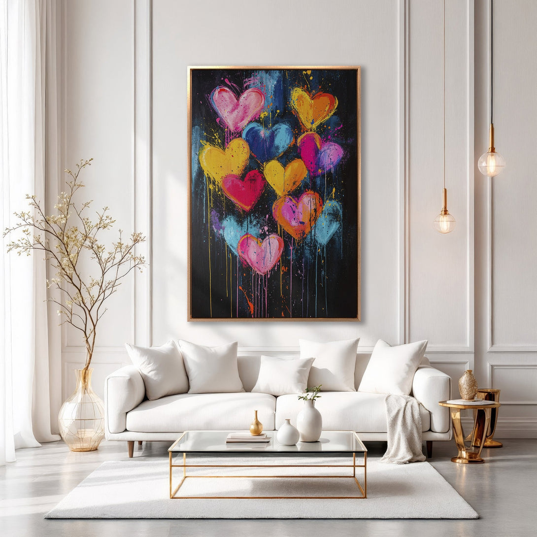 Framed Wall Art: Vibrant heart painting in a modern living room. Colorful abstract art with pink, yellow, blue hearts against a black background.