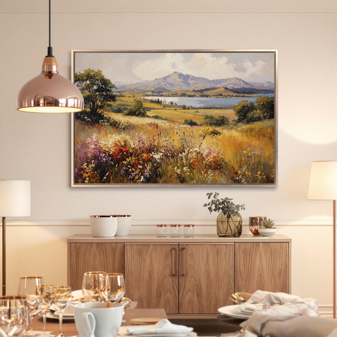 Framed Wall Art: Landscape painting of a field with mountains in warm yellow, orange, and green tones. Perfect for adding a touch of nature.