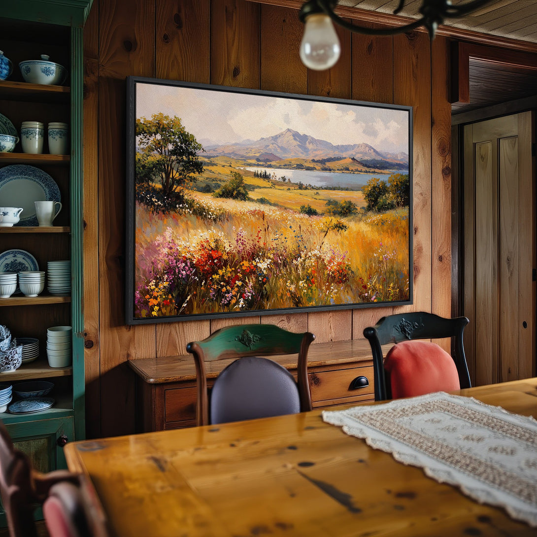 Framed Wall Art: Landscape canvas print with impressionist style, featuring a field of wildflowers and mountains. Warm, earthy tones create a cozy interior feel.
