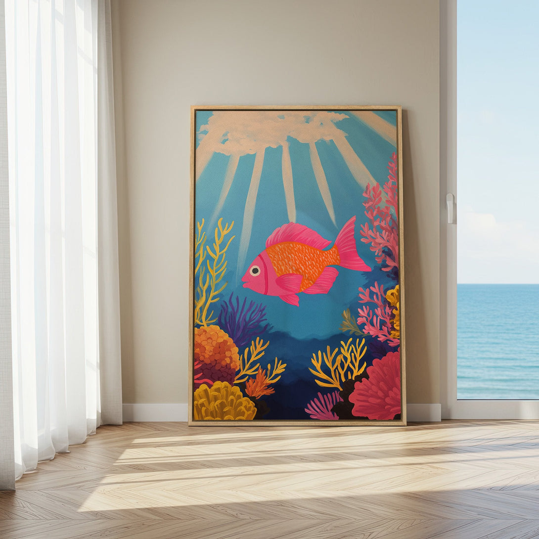 Framed Wall Art featuring a vibrant pink fish swimming in an underwater scene. Colorful, modern artwork with a blue, orange, and pink palette, perfect for coastal decor.