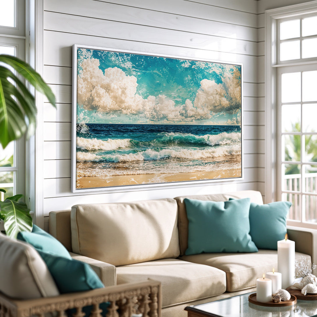 Framed Wall Art featuring a serene beach scene with blue ocean, white clouds, and sandy shore. Coastal style canvas print in a neutral color palette.