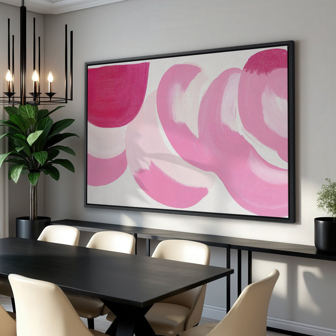 Framed Wall Art: Abstract pink brushstroke design canvas print. Modern art in a dining room setting. Stylish home decor with a pink and white color palette.
