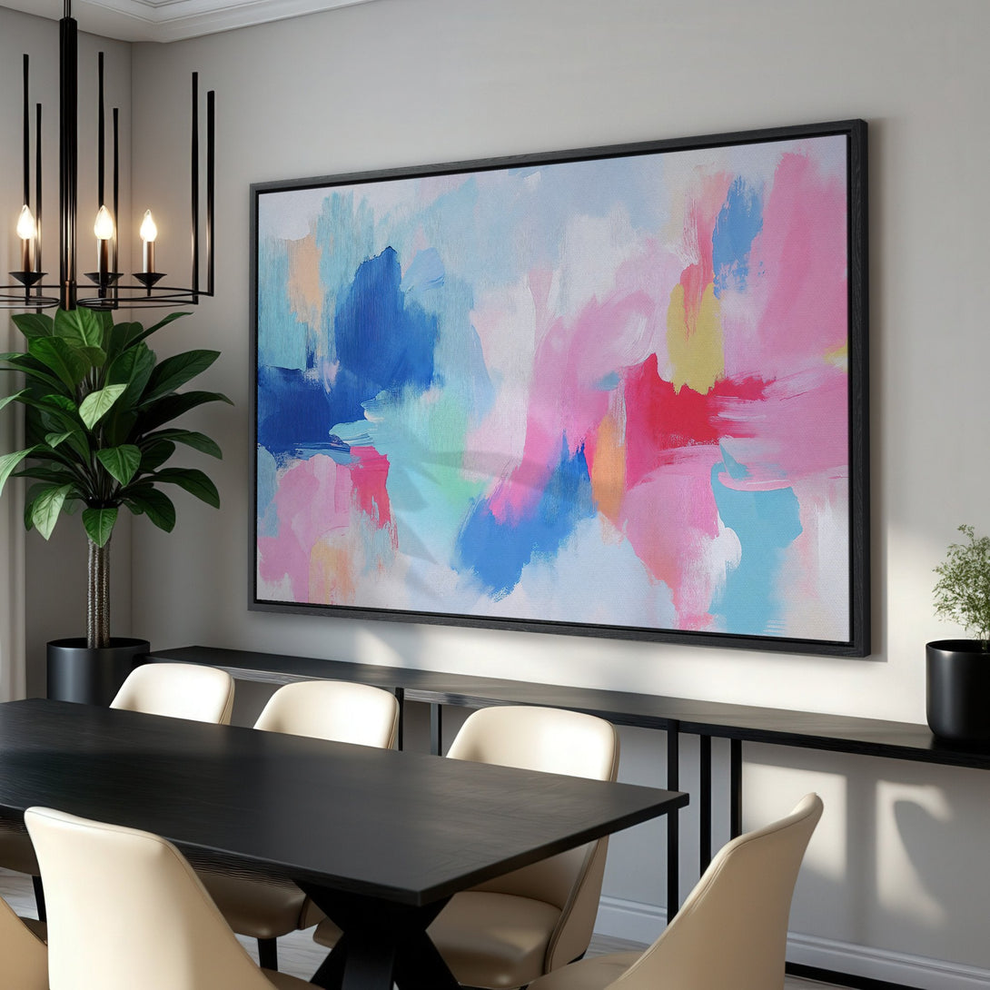 Framed Wall Art: Abstract canvas print in a modern dining room. Features a colorful palette of pink, blue, and yellow brushstrokes. Perfect for adding a pop of color!