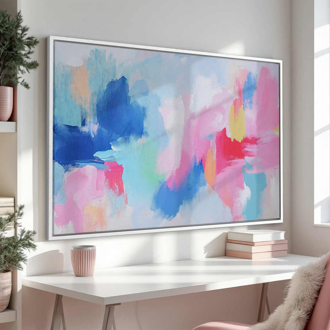 Framed Wall Art: Abstract canvas print with a vibrant, colorful palette of blues, pinks, and yellows. Modern art for a stylish interior.