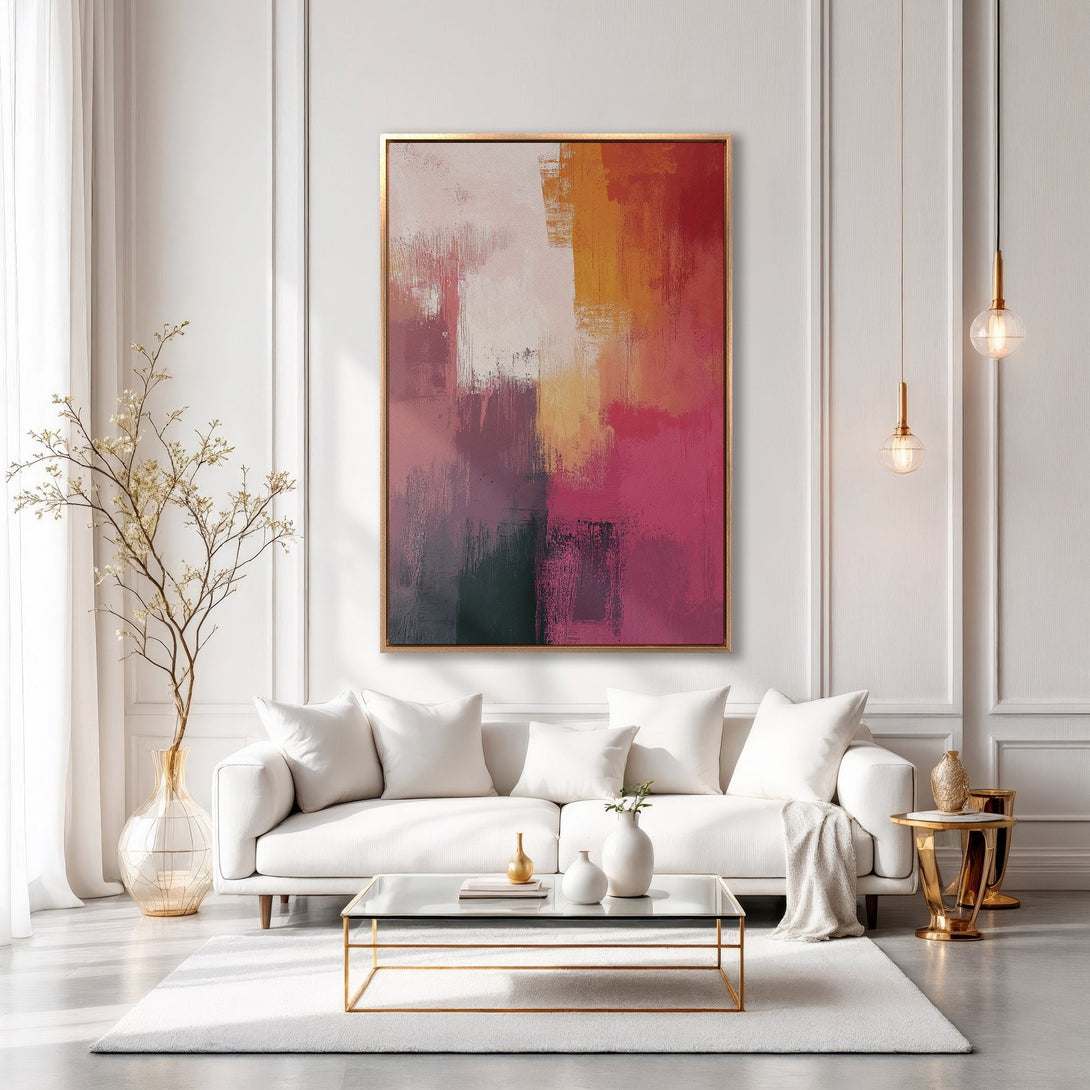 Framed Wall Art: Abstract art in warm tones of pink, orange, and red. Modern interior with white sofa. Perfect for living room decor.