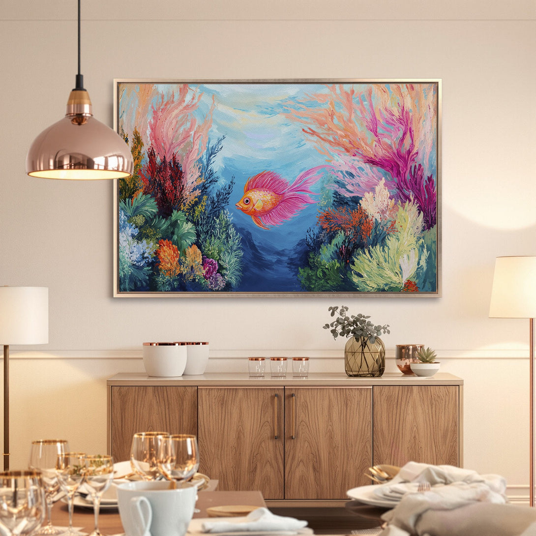 Framed Wall Art: Vibrant underwater scene with a pink fish, coral, and blue hues. Perfect for adding a pop of color to your dining room!