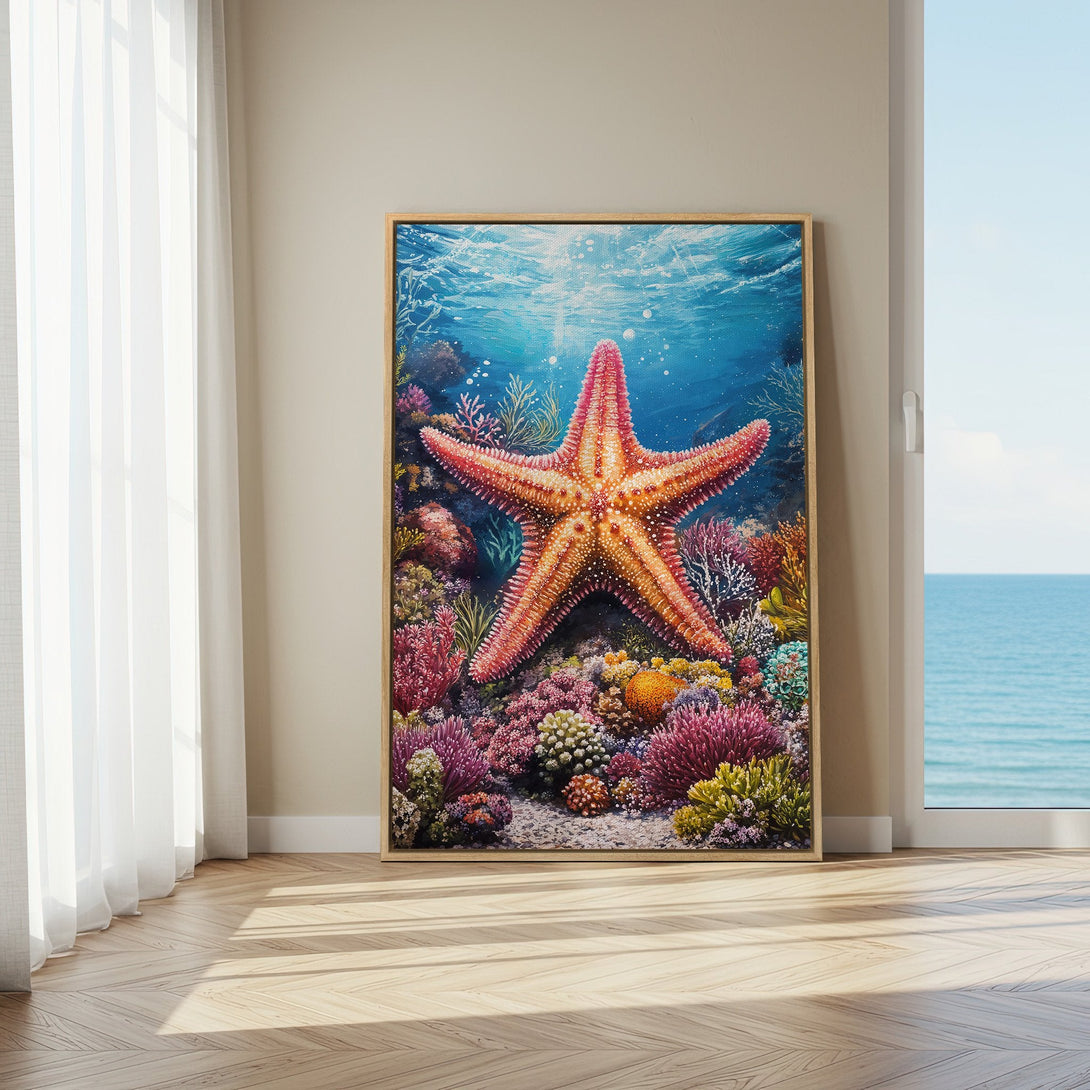 Framed Wall Art: Stunning starfish canvas print with vibrant coral reef scene. Coastal decor in blue, pink, and orange hues, perfect for a beachy interior.