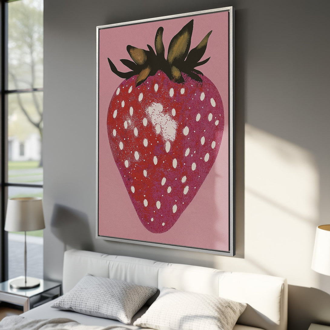 Framed Wall Art: Whimsical strawberry canvas print in a modern bedroom. Features a bold, pop art style with a pink, red, and white color palette. Perfect for adding a touch of fun!