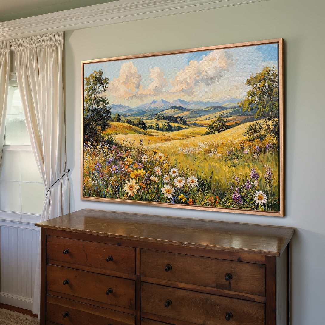 Framed Wall Art: Landscape painting with wildflowers in a golden field, blue sky, and mountains. Warm, inviting colors perfect for any room.