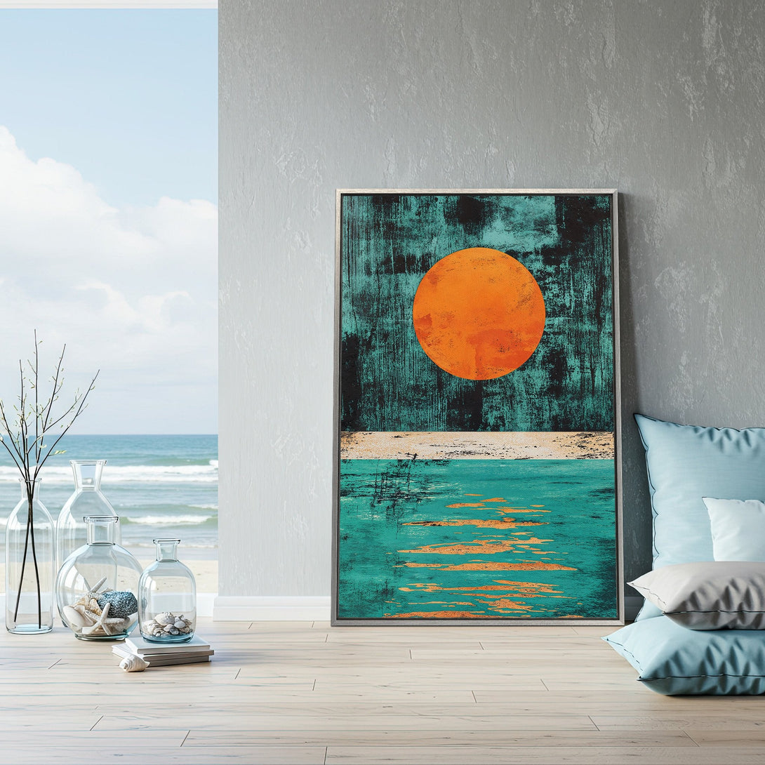 Framed Wall Art featuring an abstract sunset over the ocean. Coastal decor in teal, orange, and black. Perfect for a modern living room.