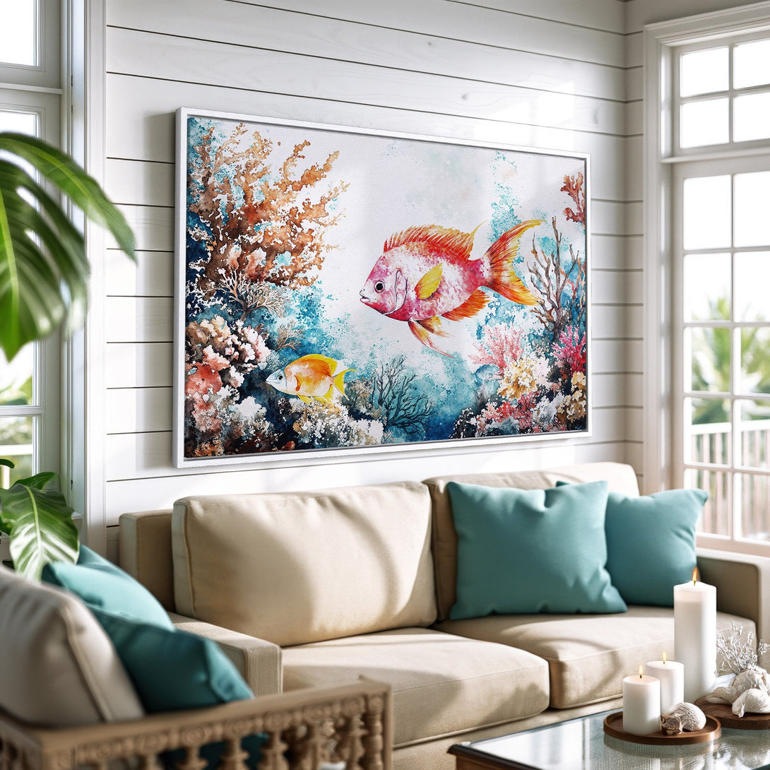 Framed Wall Art: Watercolor fish art in a coastal living room. Vibrant coral reef scene with red, blue, and orange hues. Perfect for beach house decor.