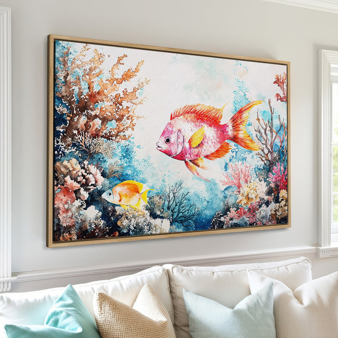 Framed Wall Art featuring vibrant watercolor fish and coral. Coastal-inspired artwork with a blue, orange, and pink color palette. Perfect for adding a splash of color!
