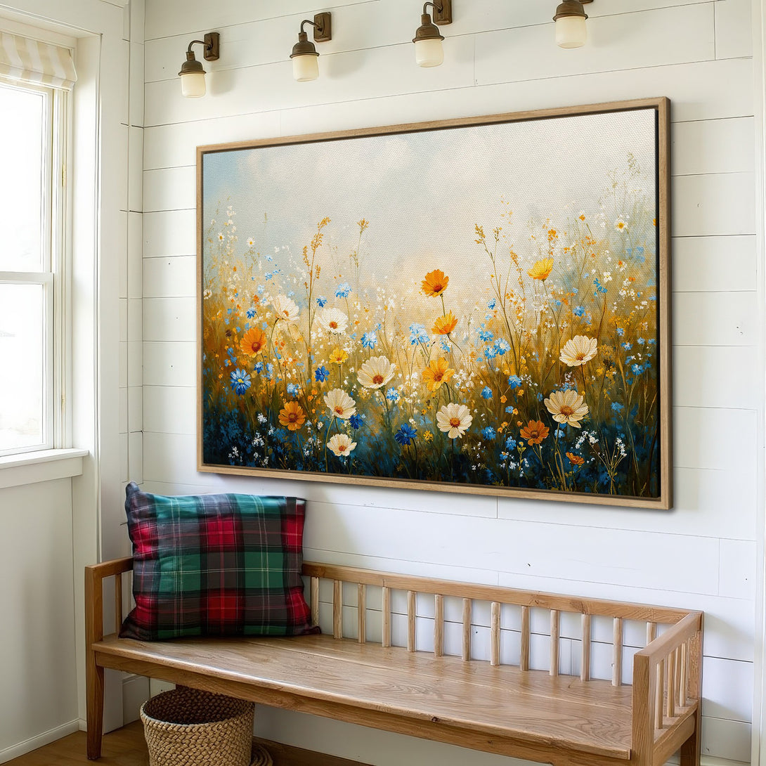 Framed Wall Art: Floral canvas print in a rustic interior. Features a wildflower meadow in warm yellow, blue, and white tones. Perfect for adding a touch of nature.