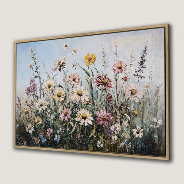 Framed Wall Art of a vibrant wildflower meadow. Impressionistic style with a soft, colorful palette of pinks, yellows, and greens against a blue sky.