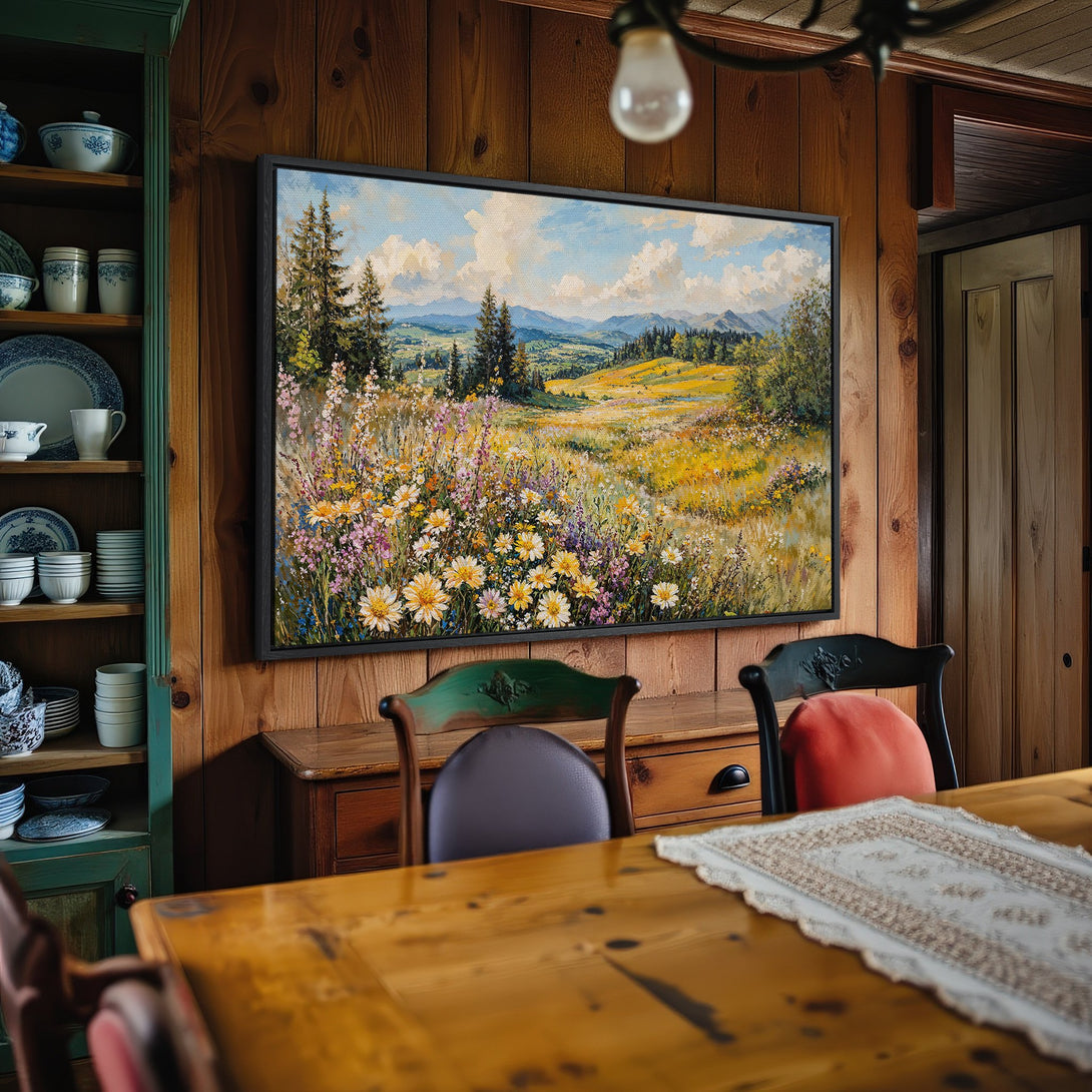 Framed Wall Art: Landscape painting of wildflowers and mountains, warm yellow and blue color palette, adds rustic charm to any interior.