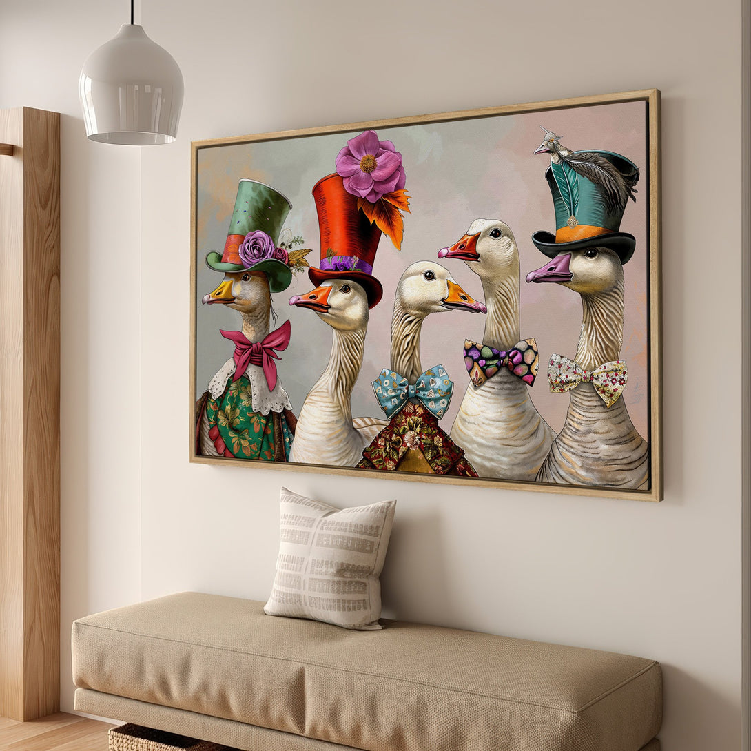 Framed Wall Art featuring whimsical geese in hats and bowties. Colorful illustration with pink, green, and gold accents. Perfect for adding character to your home!
