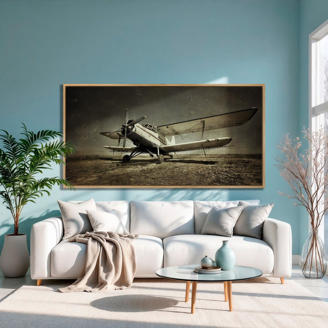 Framed Wall Art: Vintage airplane print in a living room. Rustic style with neutral tones and a pop of blue. Perfect for a cozy space!