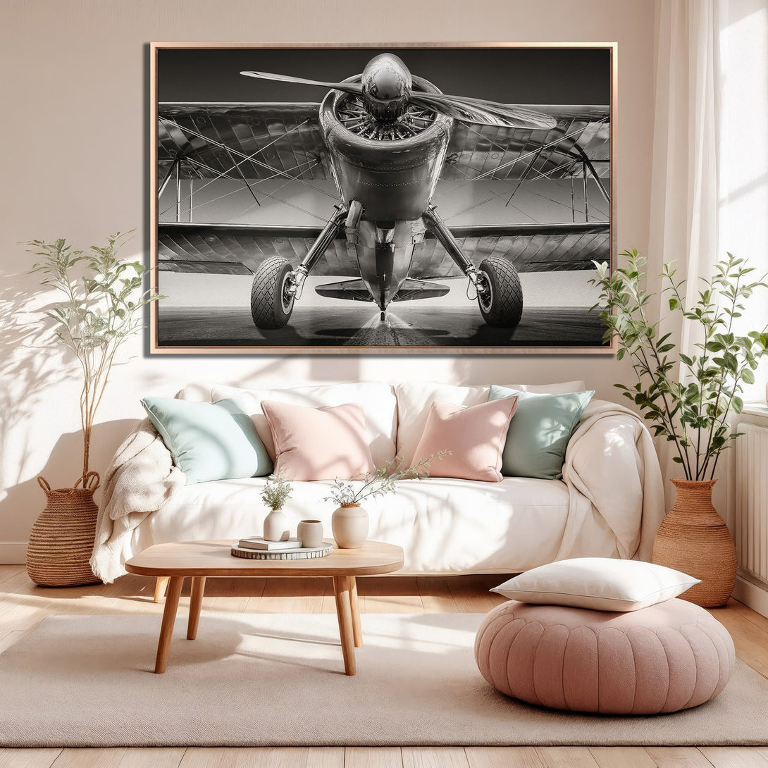 Framed Wall Art: Vintage biplane Canvas Print in monochrome. Adds a touch of classic aviation style to any space. Neutral color palette enhances modern interiors.