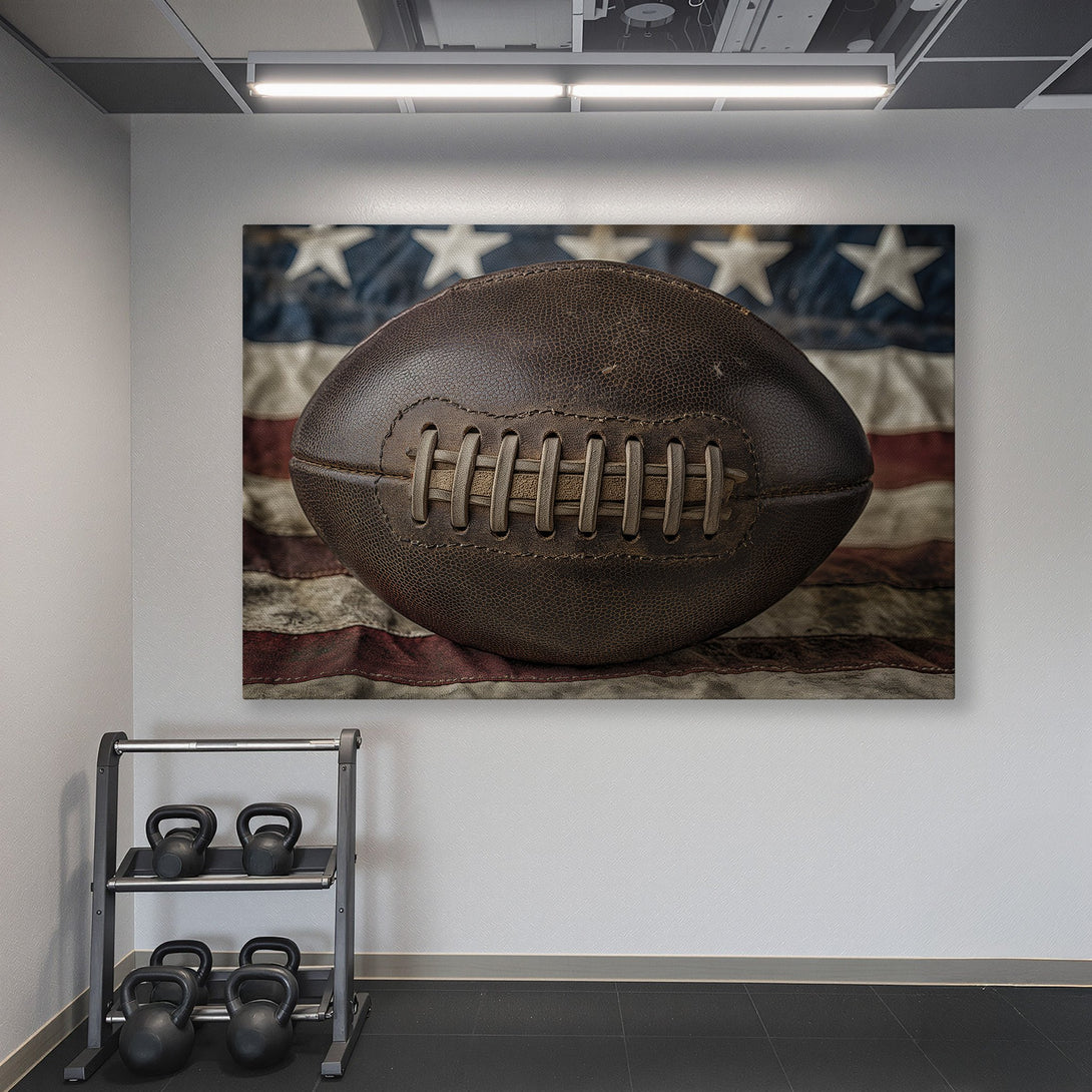 Framed Wall Art: Vintage football canvas print in a home gym. Rustic, patriotic design with brown, blue, and gold tones. Perfect for sports fans!