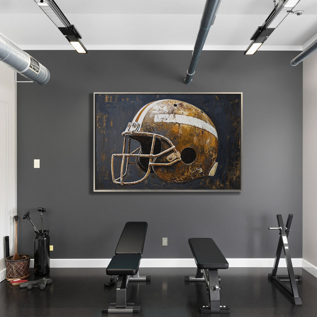 Framed Wall Art: Rustic football helmet canvas print in a modern gym setting. Features a distressed style with a warm, earthy color palette. Perfect for sports fans!